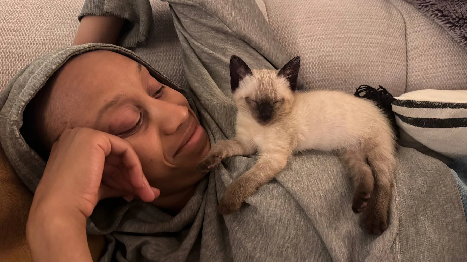 Diara gently holding a kitten