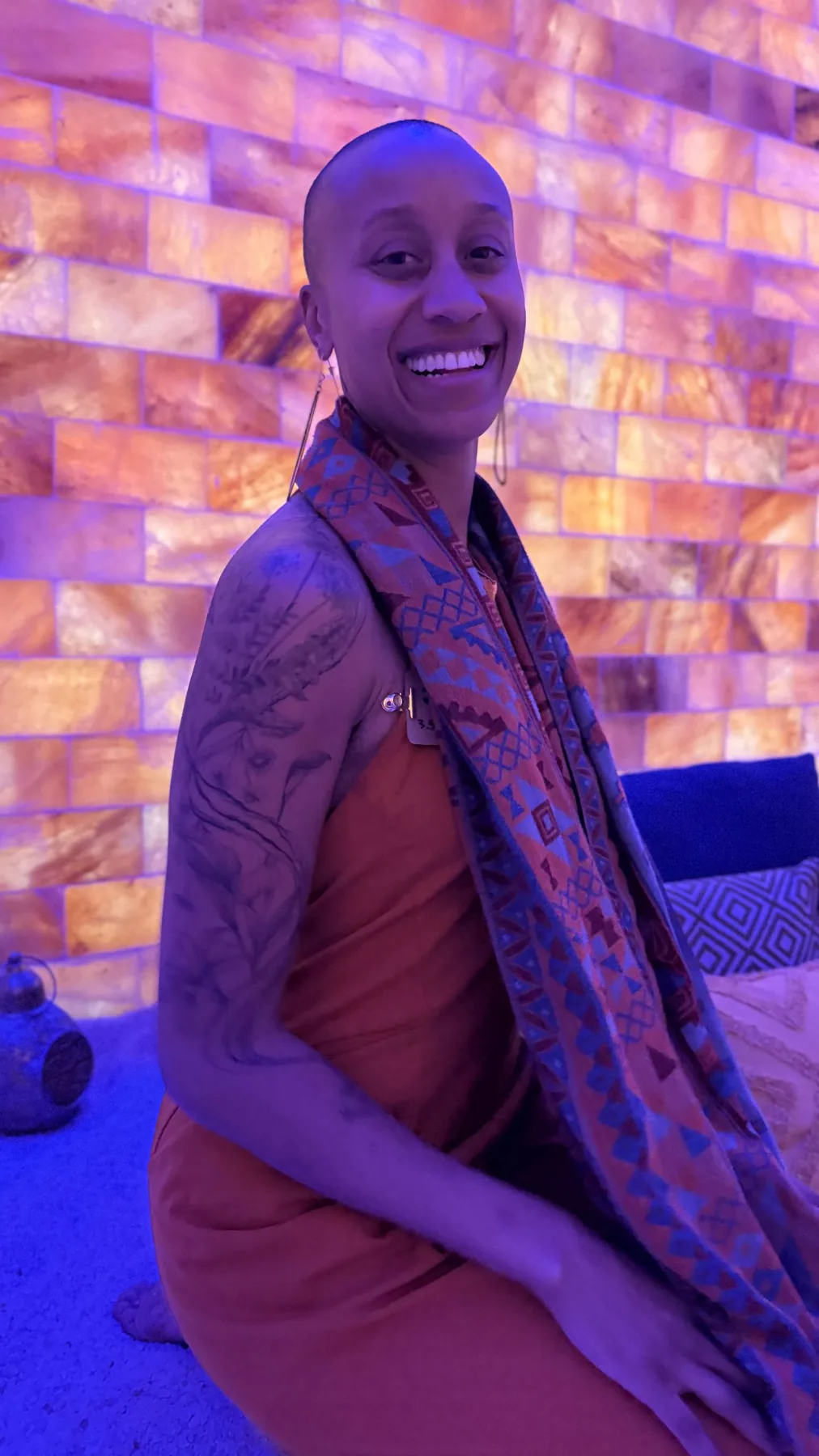 Diara standing in warm violet and gold light